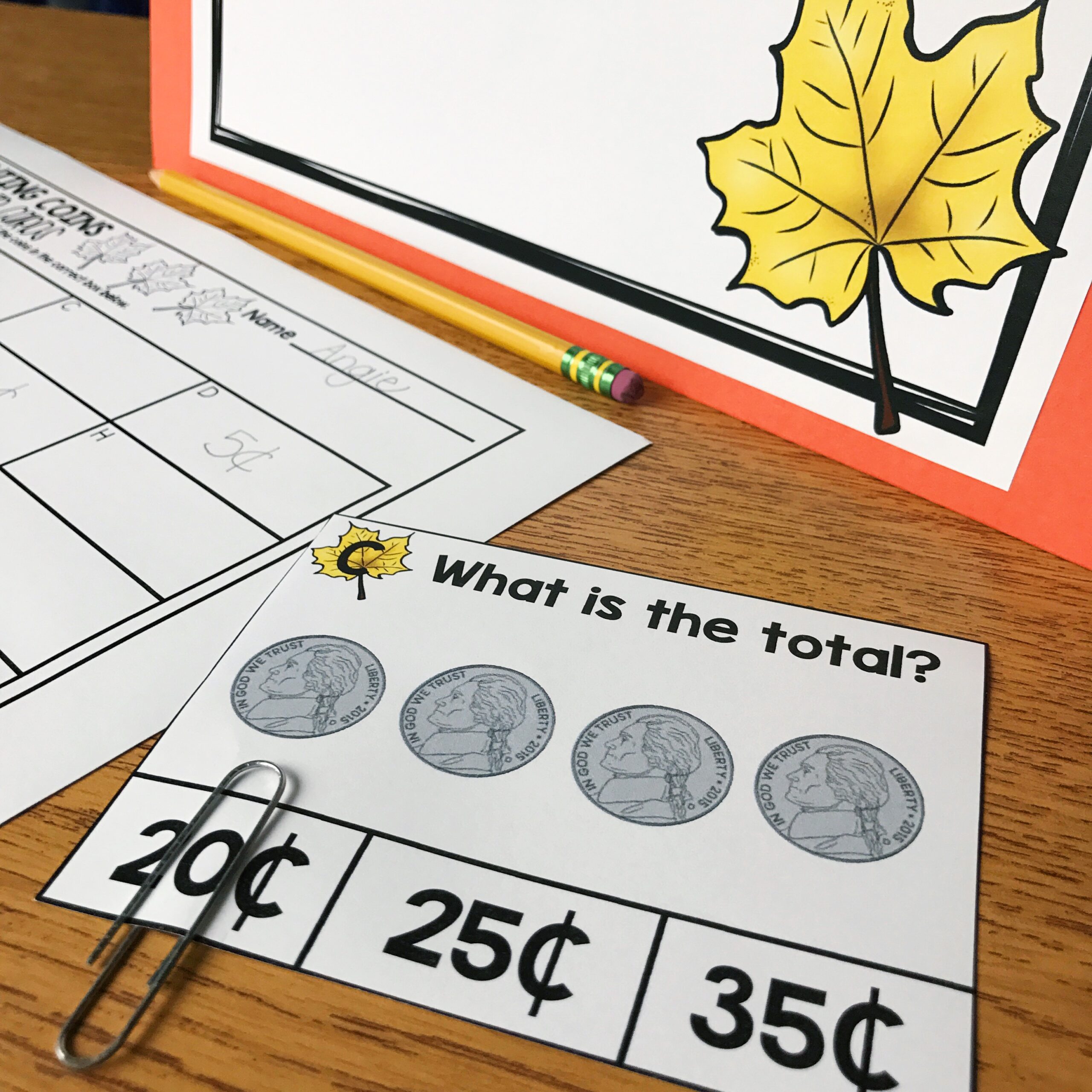 An engaging October math activity for 2nd grade students featuring coin addition with images of quarters, dimes, nickels, and pennies, perfect for classroom learning and practice.