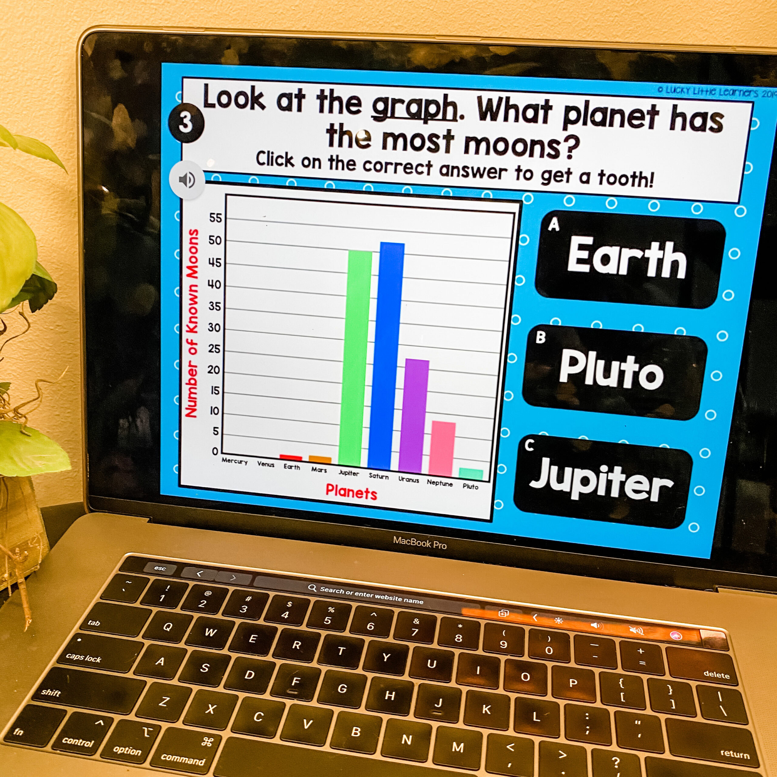 Earth planet graph for 1st grade digital reading Toothy Bundle, showing moon counts, with multiple-choice options Pluto, Earth, Jupiter, on a laptop screen.