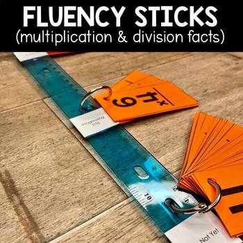 Multiplication and division fluency sticks with orange cards and a clear ruler, designed to help students practice and improve their math facts for better multiplication and division skills.