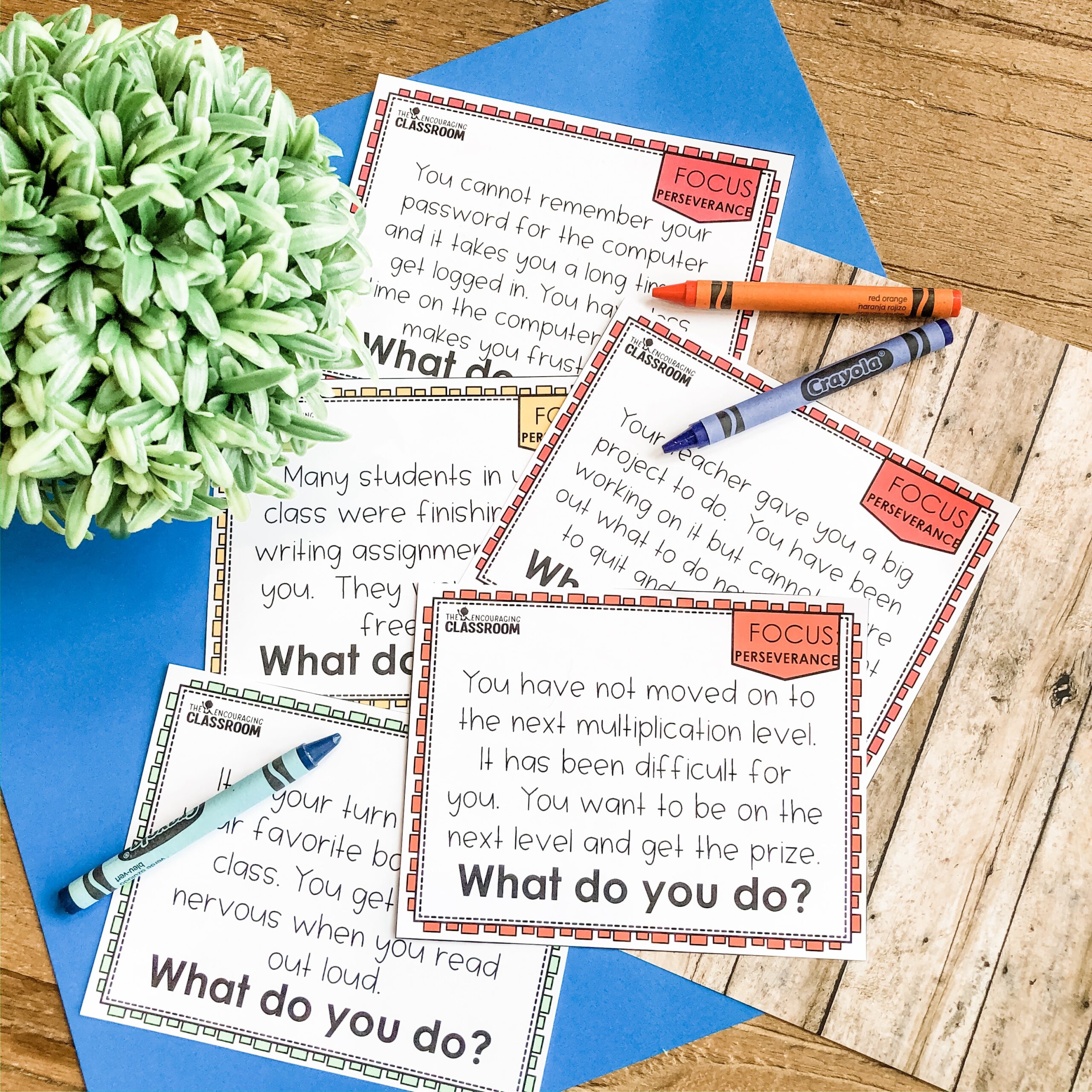 First and second grade social emotional learning perseverance activity with classroom worksheets, pens, and a plant, focusing on building resilience and growth mindset in young students.