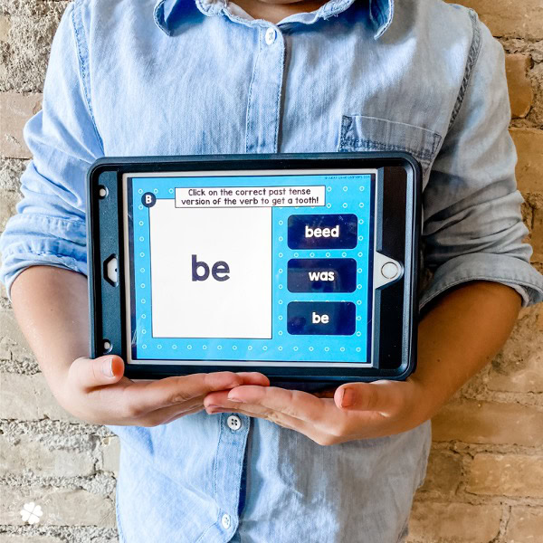 Click on the correct past tense verb to complete the teeth-themed grammar task card for 2nd and 3rd grade students, featuring digital interactive content for language learning.