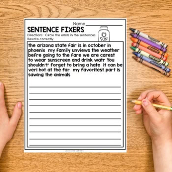 A colorful educational worksheet titled "Sentence Fixers #2" with a hand holding a pencil, surrounded by crayons, designed for practicing sentence correction and literacy skills.