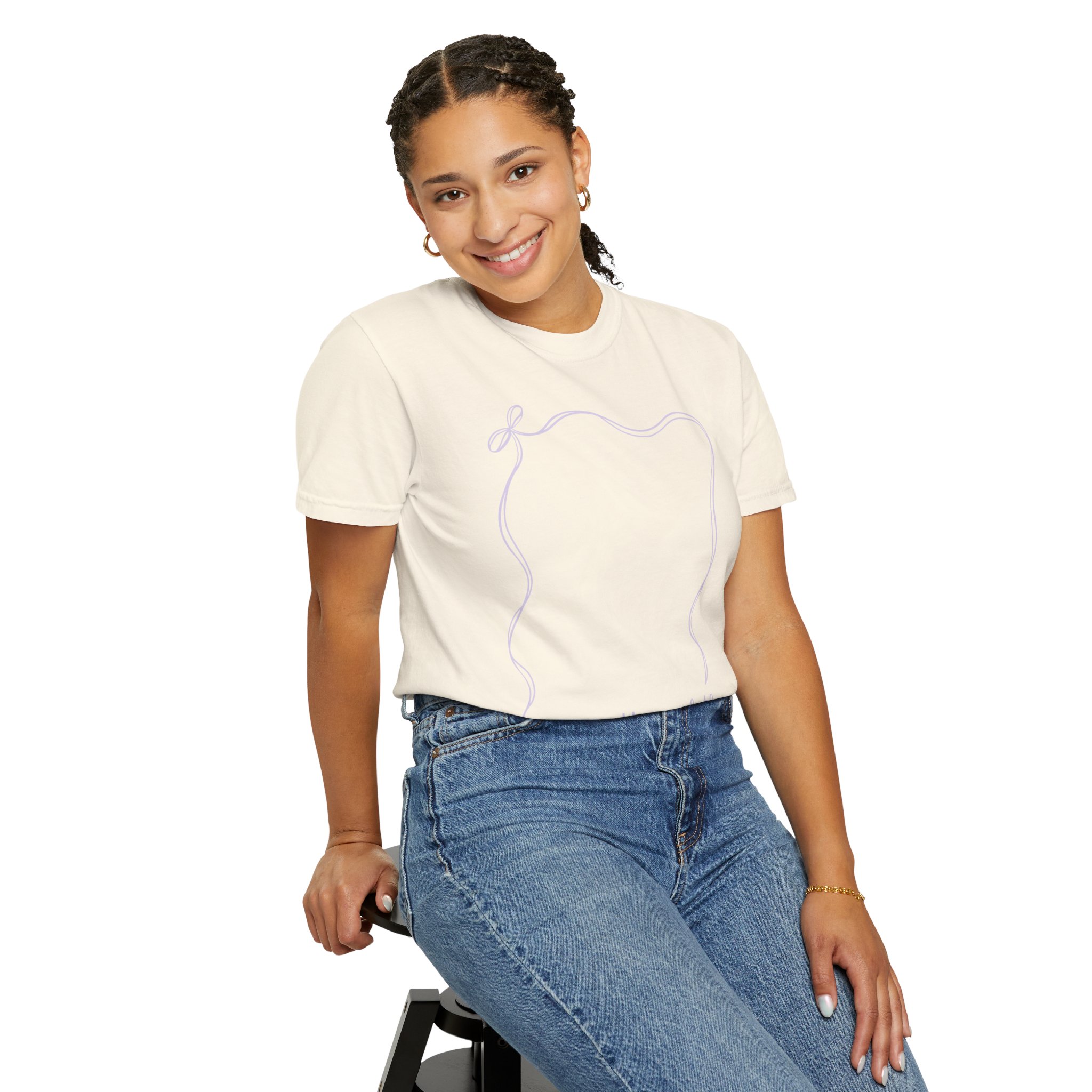 A cheerful young girl wearing a 2nd grade autograph T-shirt with a simple line drawing of a bear's face, sitting on a stool, perfect for teacher year-end keepsakes and classroom memories.