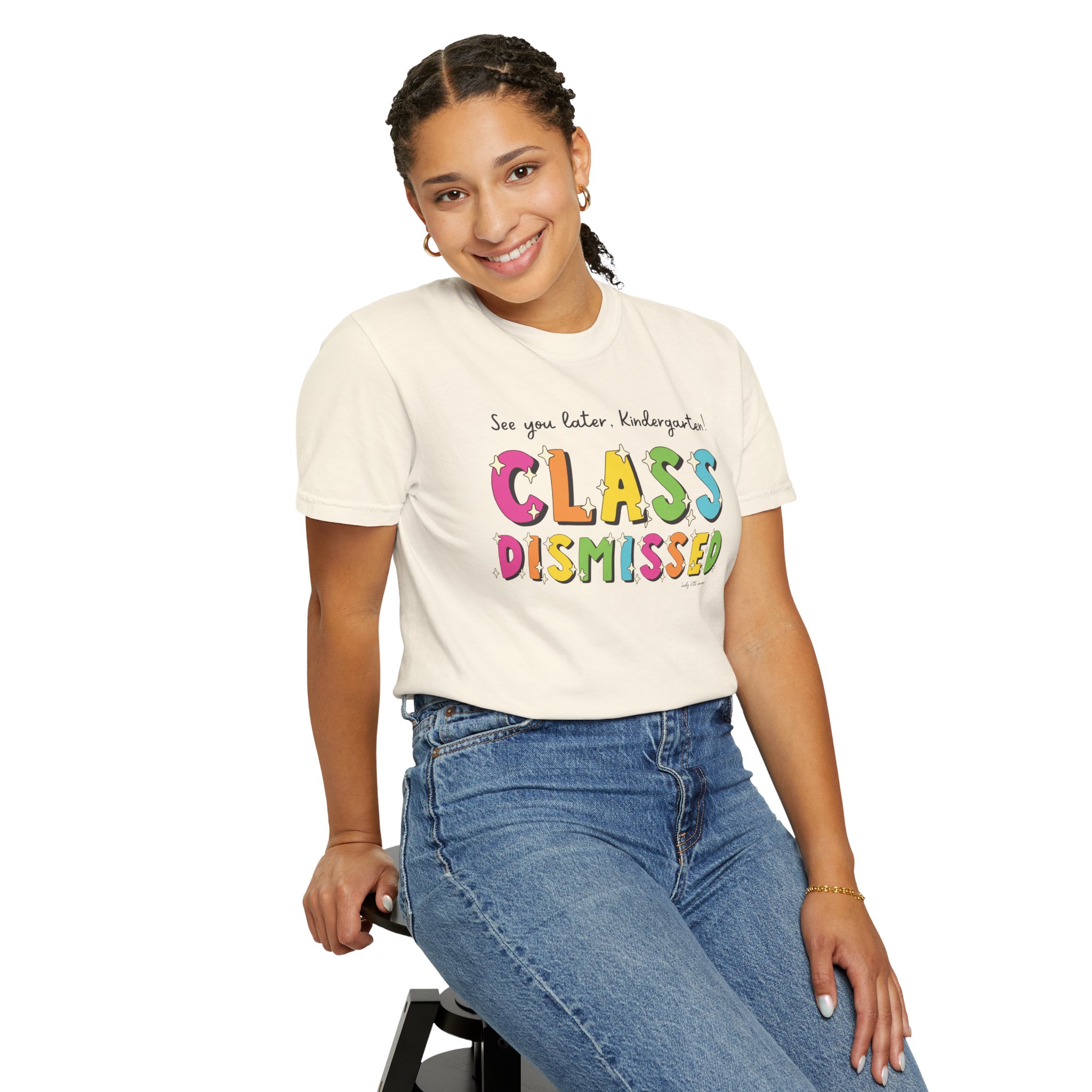 Enjoyable young girl smiling while wearing a "Class Dismissed" kindergarten T-shirt, perfect for celebrating the end of the school year and showcasing fun, colorful educational apparel.