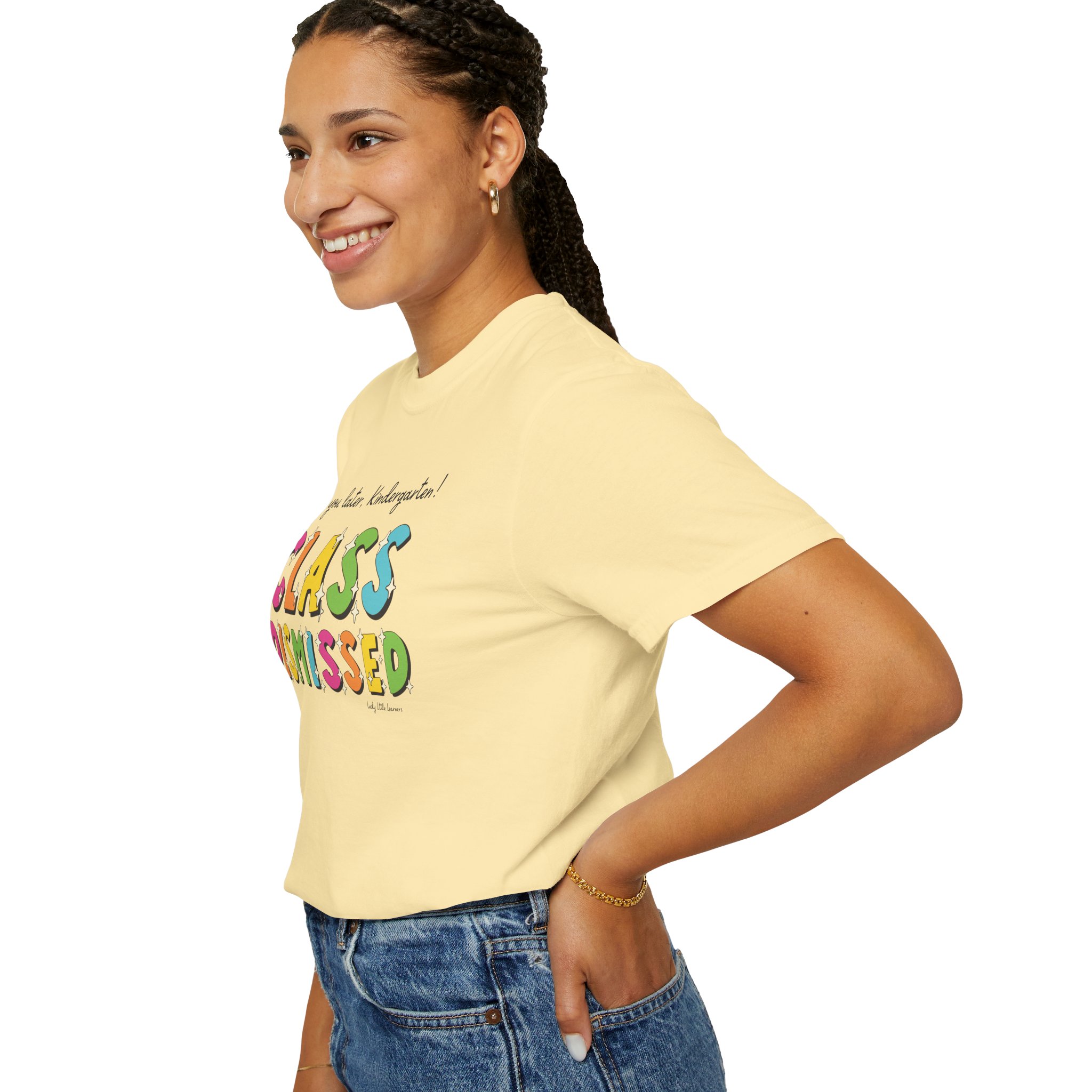 Enjoyable classroom moment with a smiling young girl wearing a "Class Dismissed" kindergarten T-shirt, perfect for teachers and students celebrating the end of school.