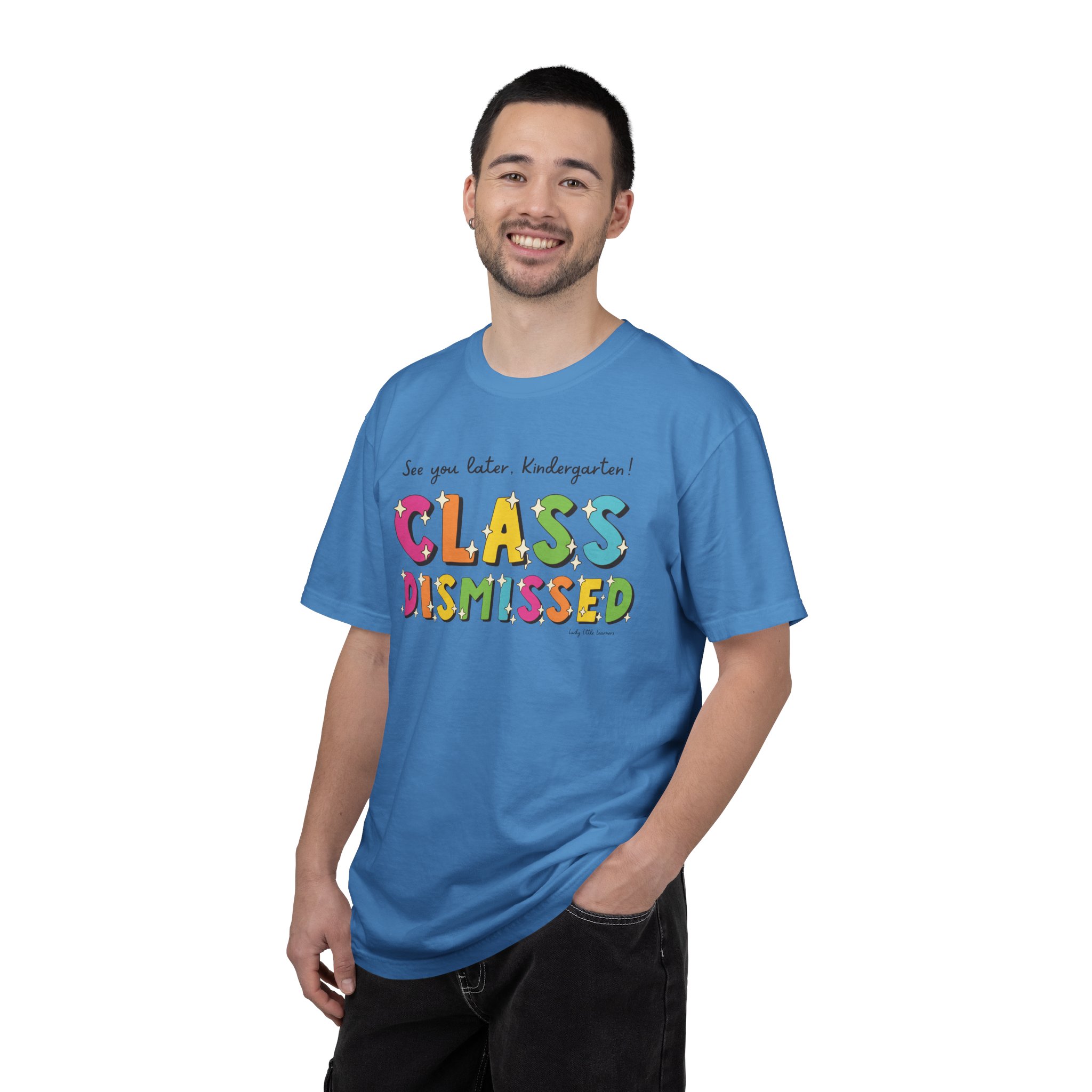 A cheerful man wearing a bright blue "Class Dismissed" kindergarten T-shirt with colorful, playful lettering, perfect for celebrating the end of the school year and promoting fun, educational apparel.