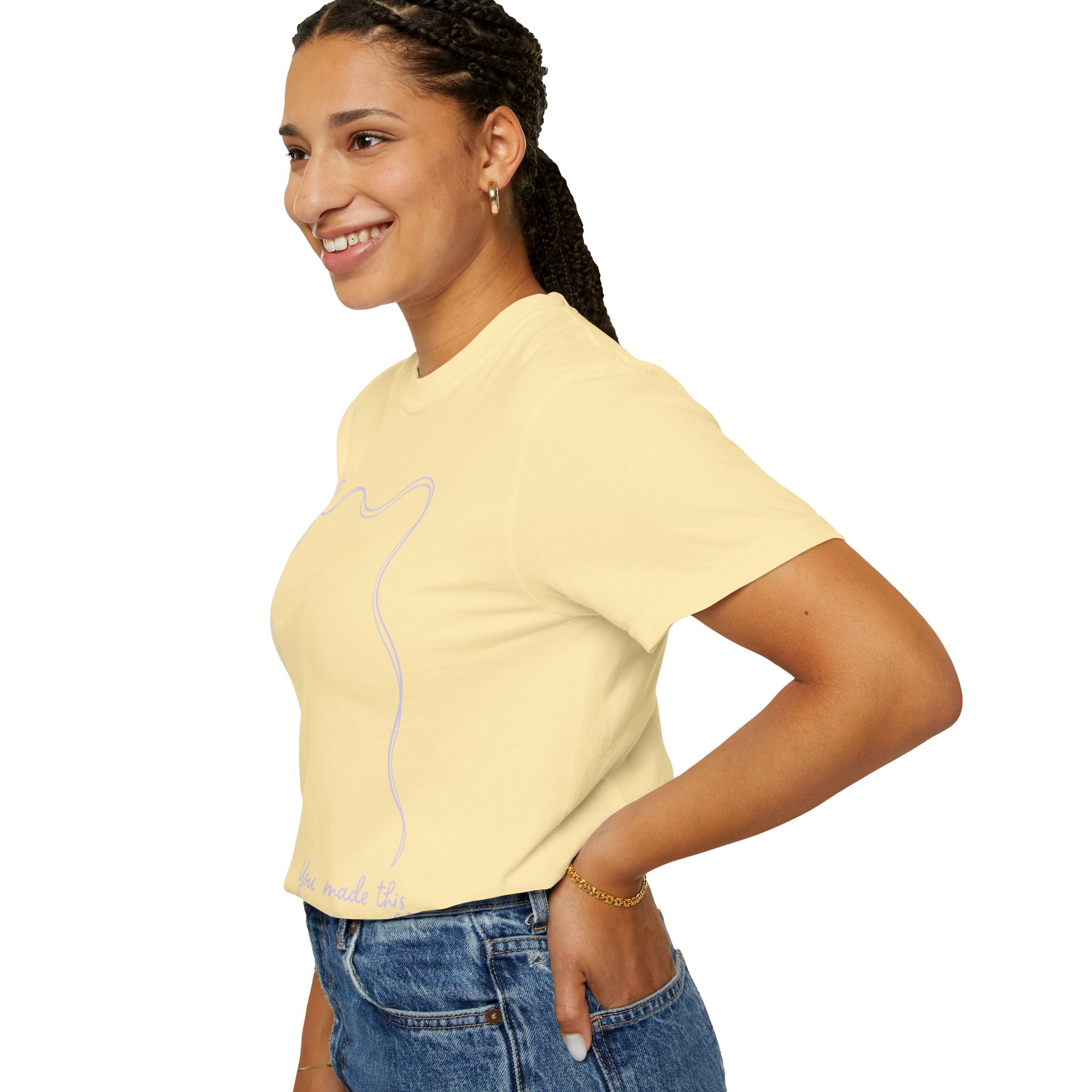 A woman wearing a 2nd grade autograph T-shirt with a simple line drawing of a cat, smiling and standing with her hand on her hip, showcasing a teacher wearable year-end keepsake.